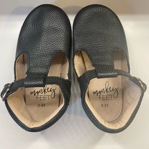 Monkey Feet Black T strap moccasins.